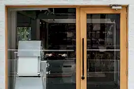 Restaurant door handle with push sign on glass.