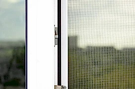 Worker using screwdriver to repair upvc window.