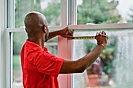 Glass Doctor professional measuring a window.