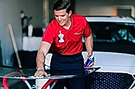 Glass Doctor professional wiping down windshield.
