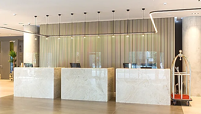 Interior of a hotel lobby with reception desks with transparent plexiglass