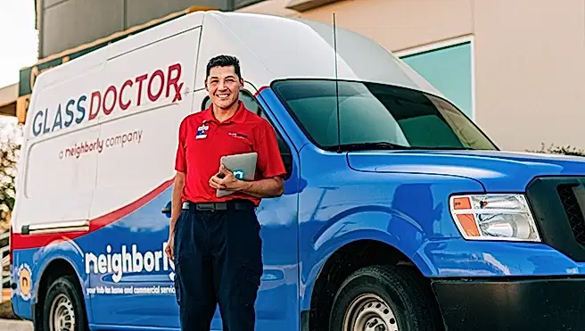 Glass Doctor professional standing near van.