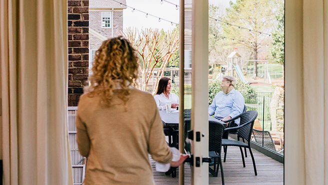 Woman walking through patio doors.