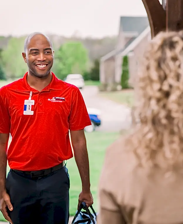 Glass Doctor professional greeting customer at front door.