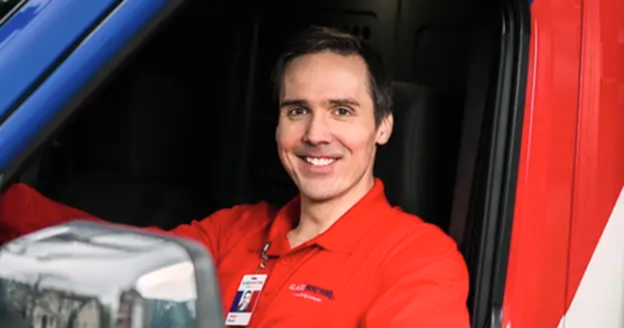 A glass doctor technician in a van.