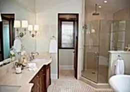 Remodeled bathroom with new glass shower doors and bathroom mirror.