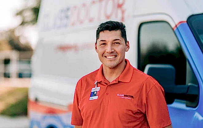 Glass Doctor professional smiling and standing by company van.