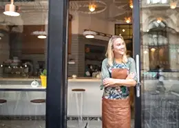 Women standing in front of glass storefront door.